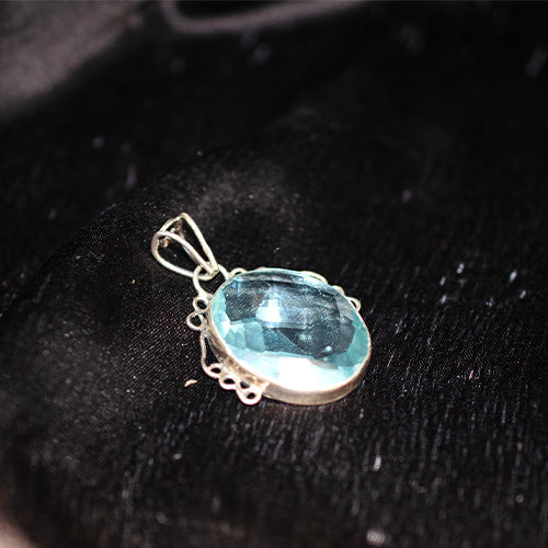 925 Sterling Silver Faceted Blue Topaz Oval Pendant with Scroll Setting